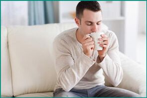 A man drinks peppermint tea, wanting to cure erectile dysfunction. 